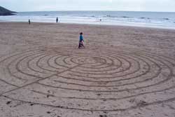 Alicia walks a Celtic labyrinth, made on a beach in Wales.